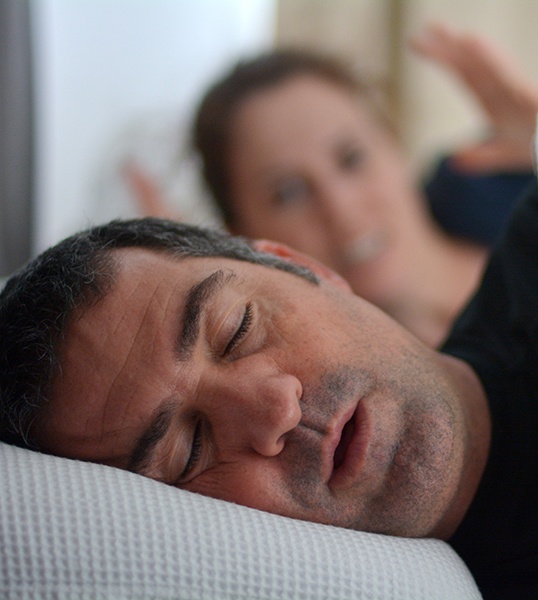 Man snoring in bed