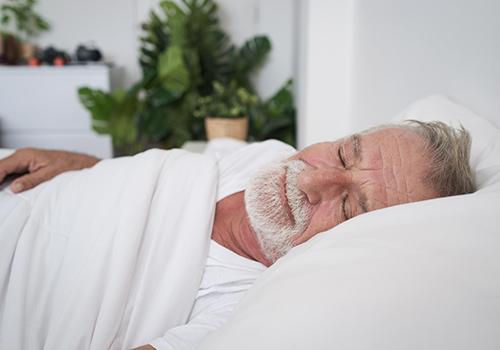 Man sleeping in a bed