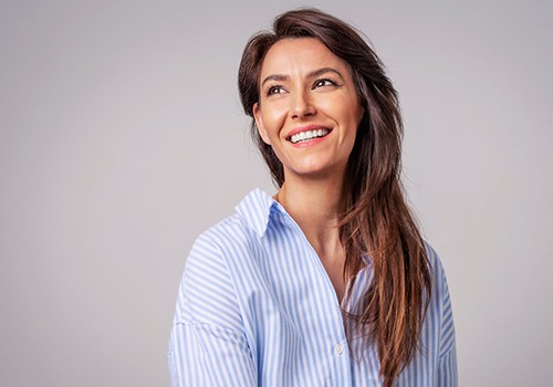 Smiling woman in blue and white striped shirt