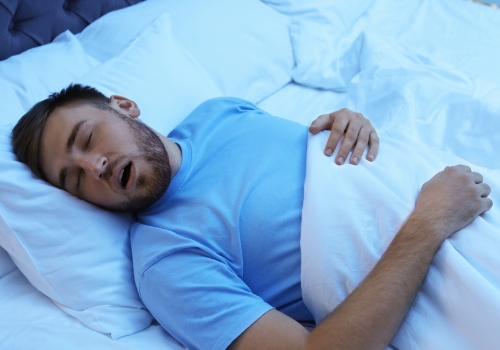 Man sleeping on his back with his mouth open
