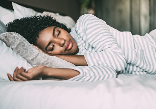 Sleeping woman in striped pajamas