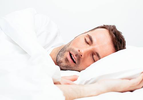 Man snoring with his mouth open