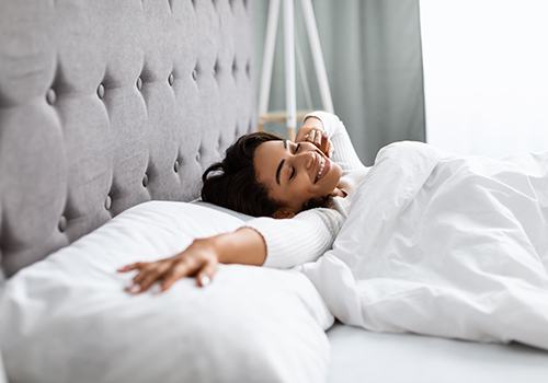 Woman waking up with a smile on her face