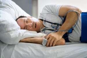 Man sleeping while connected to monitoring equipment